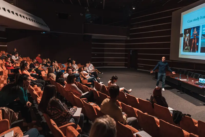 Fitness professionals attending a seminar in a large lecture hall